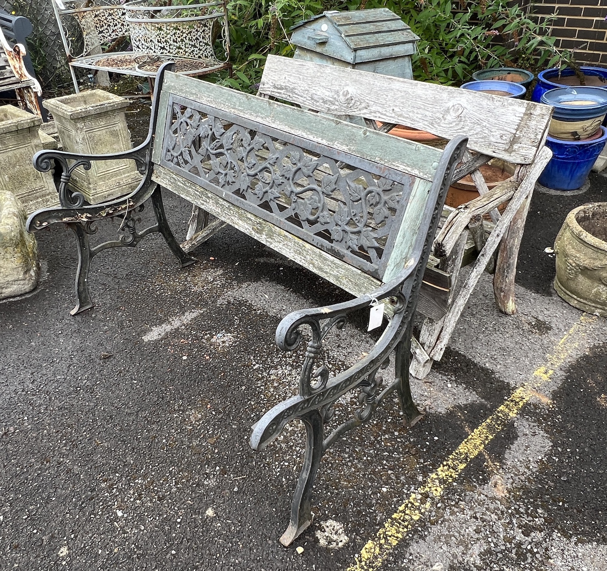 A rustic wooden garden bench, width 133cm, depth 58cm, height 74cm together with an aluminium garden table (in need of restoration)
